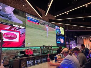 men sit at the bar and enjoy sports on the tv